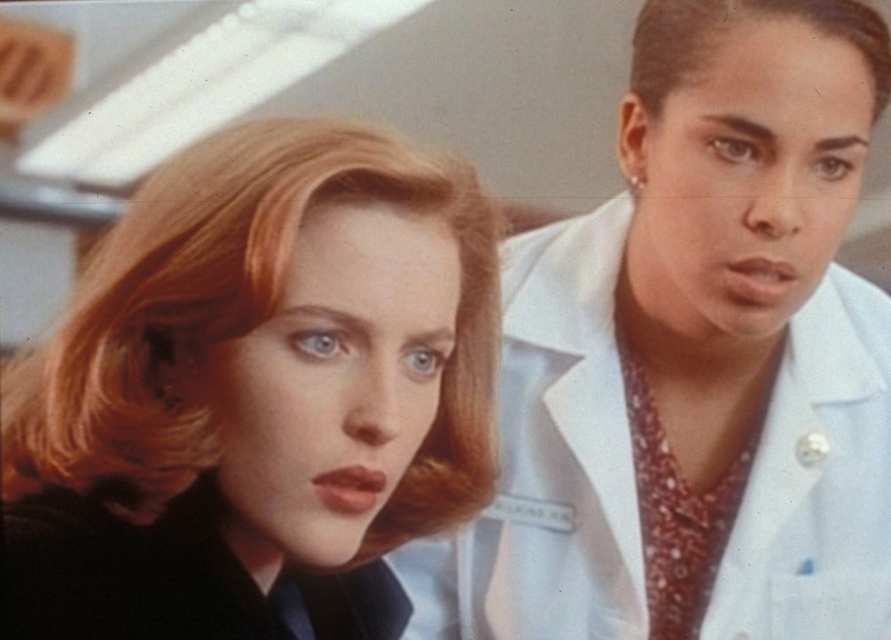 Scully (Gillian Anderson, l.) und eine Krankenschwester betrachten fassungslos die Wunden an den Händen eines 10-jährigen Jungen, die wie Kreuzigung... - Bildquelle: TM +   2000 Twentieth Century Fox Film Corporation. All Rights Reserved.